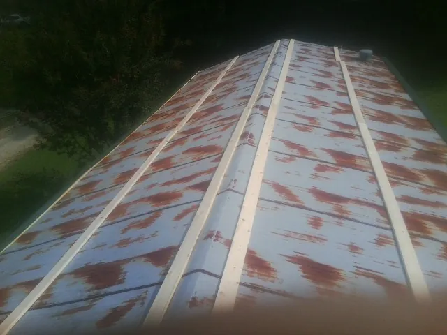 Rusted metal roof panels with new wood purlins before replacement — Storm Damage Roof Repair in Abercrombie by Roofing Brothers