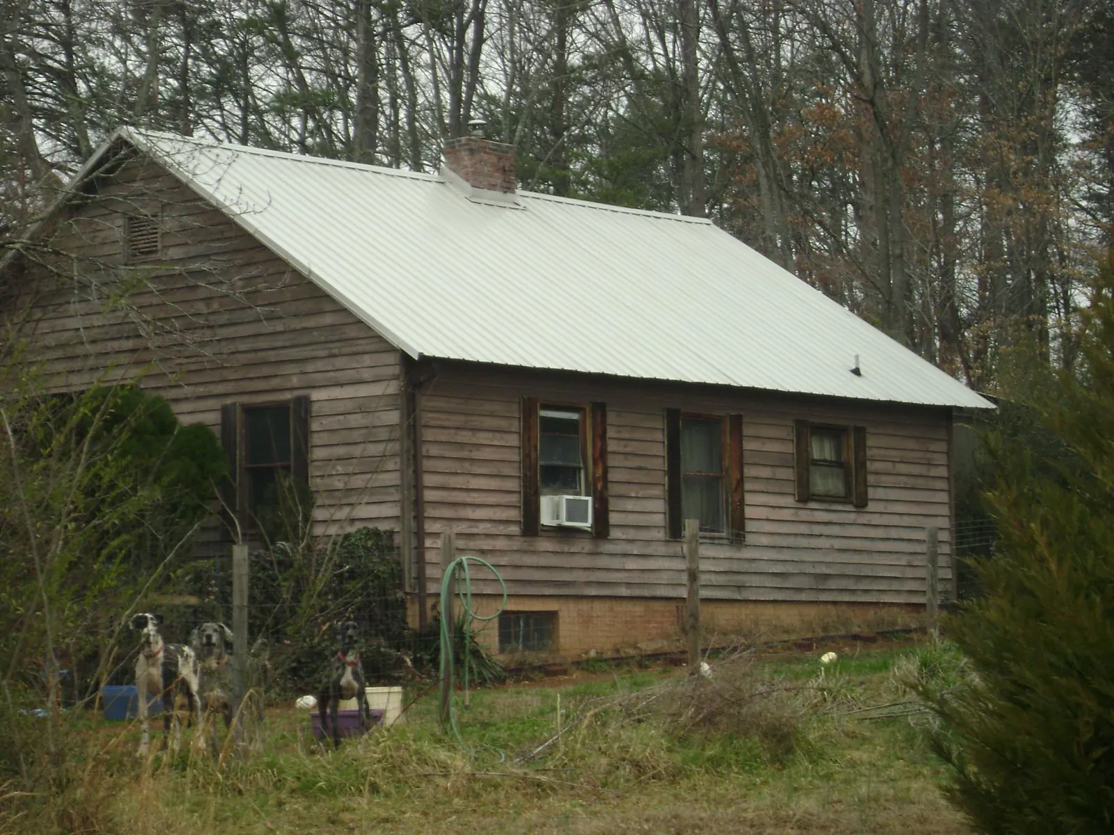 White metal roof on an old wood sided farmhouse, from a Metal Roof Installation job in Abercrombie